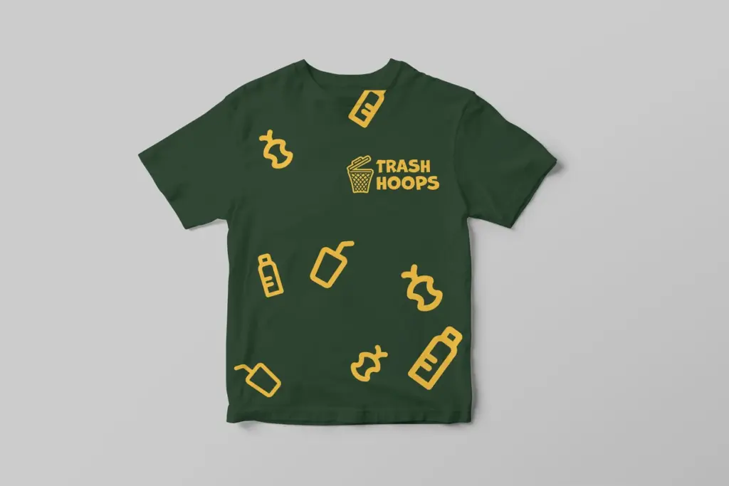 A mockup of a green T-shirt with orange graphics for Trash Hoops