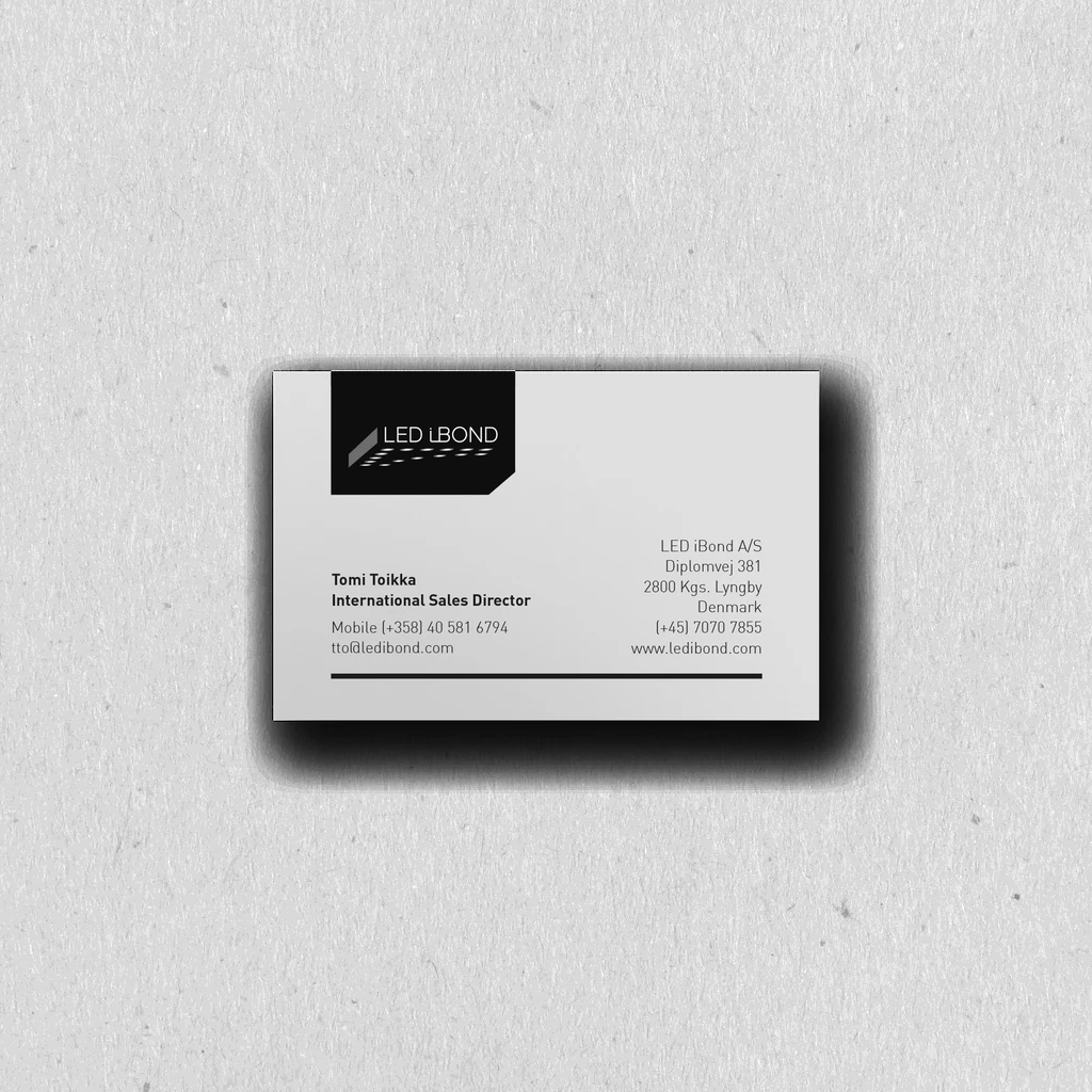 A mockup of a business card lying on a white table